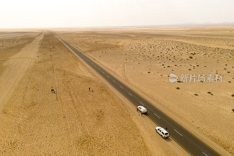 Aerial view of cars stopped on road in desert
